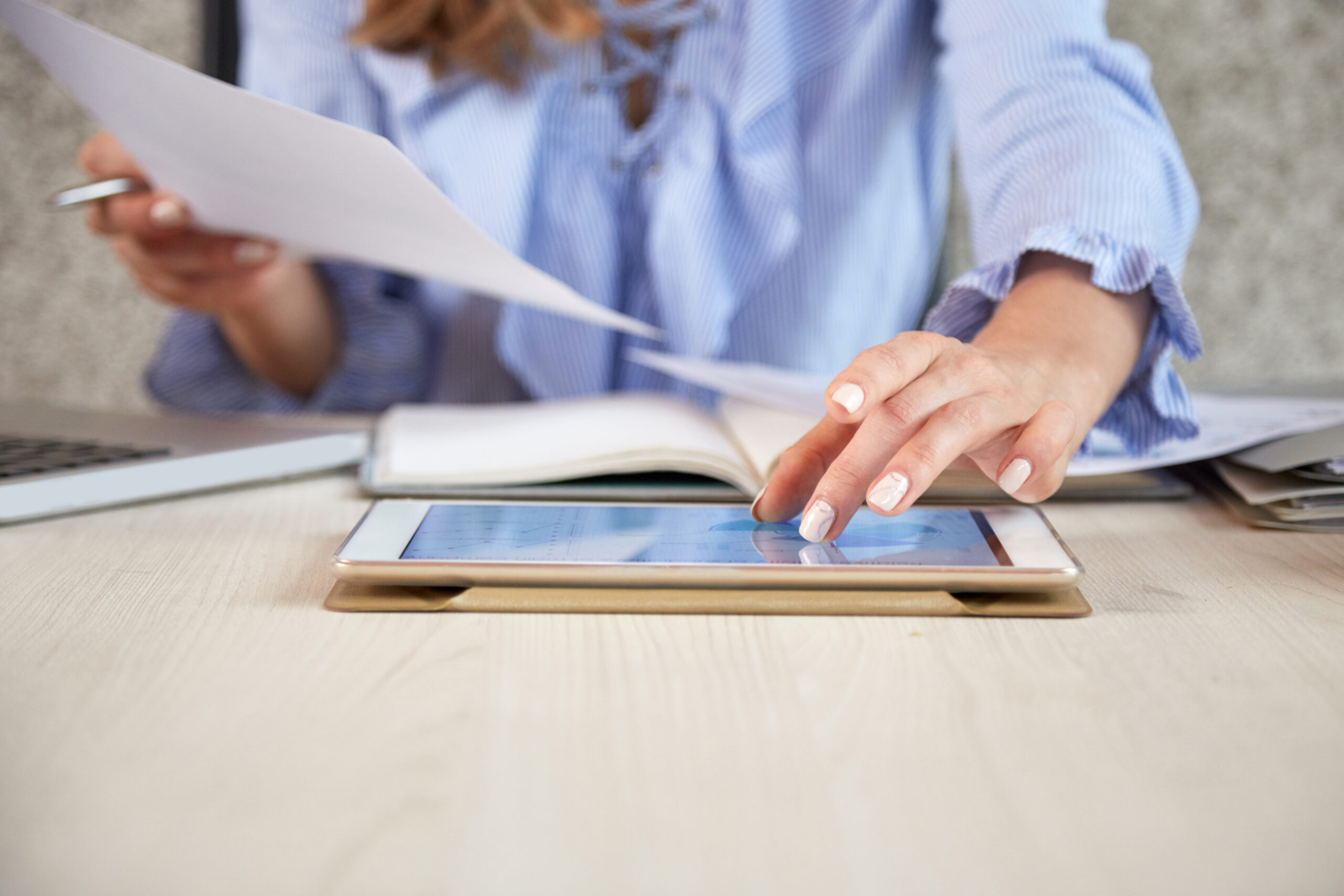 mid-section-unrecognizable-woman-working-with-tablet-pc-office-desk